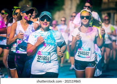 MORRISTOWN, NJ, USA - JUNE 6, 2014: Mother-daughter run the Color Vibe race. Color Vibe is a fun un-timed event with no winners or prizes where runners are showered with colored powder along the run.