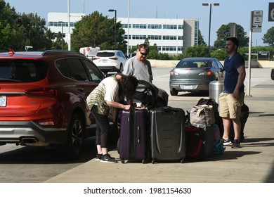 Morrisville, NC - United States- 05-27-2021: A Family Unpacks Luggage At The Curb At RDU International Airport. 