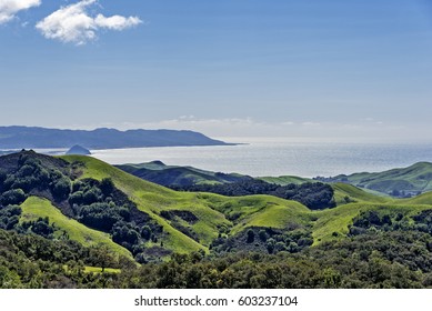 Morro Rock, Morro Bay, Montana De Oro & Rural Coastal Hills / Mountains, Blue Sky, White Clouds, & Green Grass, As Seen From Highway 46 On The Big Sur Coast, California Central Coast, Near Cambria CA.