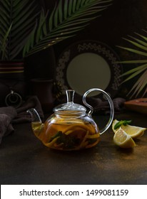 Morrocan Tea In Glass With Orange, Cinnamon, Mint, Lemon African Style Brown Texture Background 