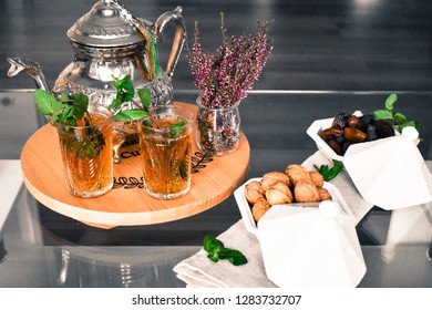 Morrocan Traditional Mint Tea In Glass And Healthy Snacks Dates And Walnuts In  Morrocan Tajine. 