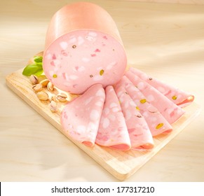 Mortadella - Bologna Sausage. Italian pork meat on wooden cutting bord. - Shutterstock ID 177317210