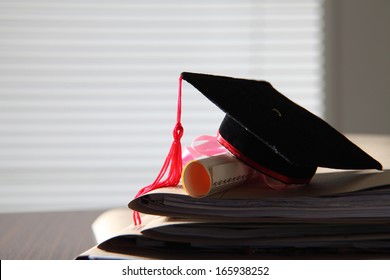 Mortar Board On Stack Of Files