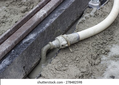 Mortar From Grout Mixer And Delivery System, Grouting Pump Used To Settle The Grout Into The Joints. Grouting Mortar And Tram Track Laying.  Selective Focus And Shallow Dof.