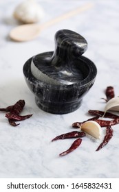 Mortar And Pestle With Spices And Herbs