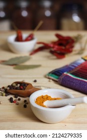 Mortar And Pestle With Turmeric And Chili Peppers 