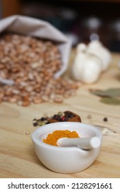 Mortar And Pestle With Turmeric And Chili Peppers