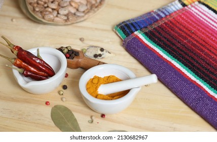 Mortar And Pestle With Turmeric And Chili Peppers