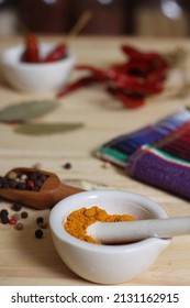 Mortar And Pestle With Turmeric And Chili Peppers Shallow DOF