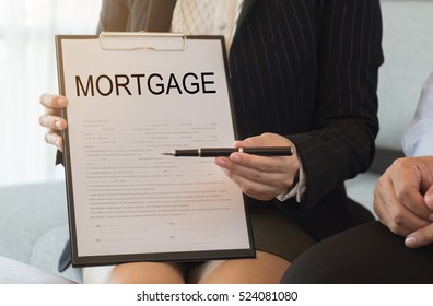 Mortgage broker or banker sends pen and mortgage loan document for signing contract. - Shutterstock ID 524081080