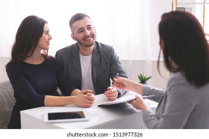 Mortgage Consultation. Young Family Listening To Financial Advisor, Ready To Sign Credit Contract At Office