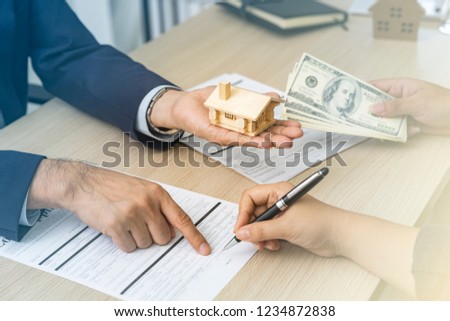 Mortgage House loan concept, Professional bank officer happy and ready to offer a special interest rate for realestate customer.