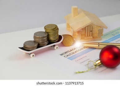 Mortgage House Loan Concept, US dollar coins stacked on sketch board, on calculation form, top down angle shooting, macro photography. - Shutterstock ID 1137913715