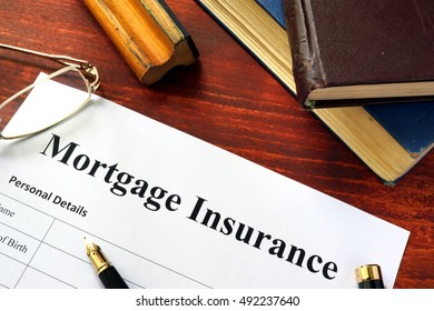 Mortgage Insurance Policy With A Book And A Pen.