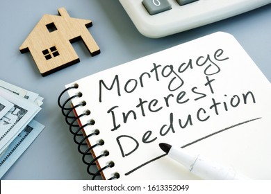 Mortgage Interest Deduction Concept. Model Of Home And Calculator.