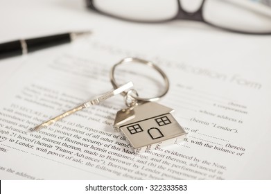 Mortgage loan agreement application with house shaped keyring - Shutterstock ID 322333583