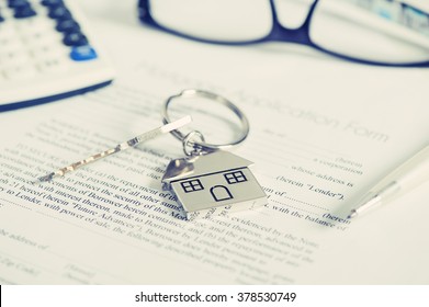 Mortgage loan agreement application with house shaped keyring - Shutterstock ID 378530749