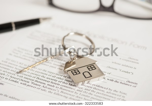 Mortgage loan agreement application with house\
shaped keyring