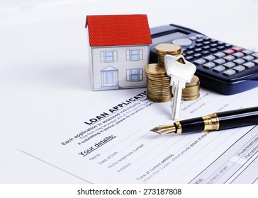 Mortgage Loans Concept With Fountain Pen And Key And Calculator And Paper House And Coins Stack On Loan Application Form