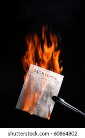 Mortgage Papers Being Burnt In Celebration Of The Mortgage Being Paid Off.