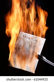 Mortgage Papers Being Burnt In Celebration Of The Mortgage Being Paid Off.