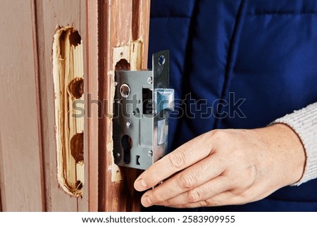 Mortise lock installation in progress by skilled professional.