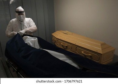 Mortuary Workers Put The Body Of A Victim Of The Coronavirus Disease Inside A Coffin At Funeral Home  In Charleroi, Belgium, On April 9, 2020