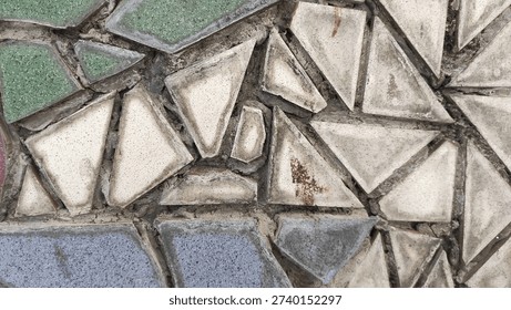 Mosaic pattern with broken tiles in various shapes and colors