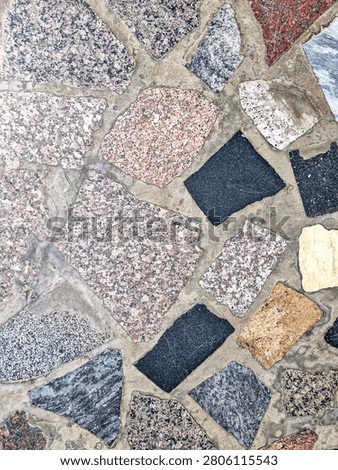 Mosaic pattern made from irregular fragments of natural stone.
