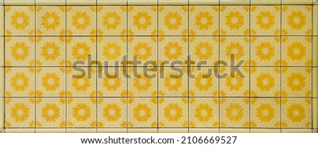 A mosaic of yellow flowered Peranakan tiles as typically found on traditional Chinese shophouses throughout Asia.