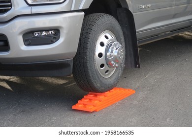 Mosca, CO USA - April 12, 2021: Heavy Duty Orange Interlocking Leveling Blocks Stack To Desired Height To Level Out A Truck Tire And Camper Rig. Level Uneven Terrain.
                            