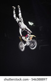 MOSCOW - 14 MARCH,2015: Extreme Sport Competition Show Proryv.Freestyle Motocross Athlete Jump High From Big Air Ramp Performing Dangerous Cliff Hanger Trick On FMX Motor Bike