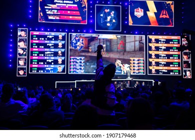 MOSCOW - 14th SEPTEMBER 2019: Esports Gaming Event. Young Man Cheer For Beloved Gamers Team At Big Arena During Tournament Game In Front Of A Big Screen.