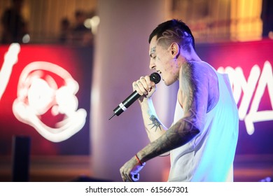 MOSCOW - 15 MAY,2016: Russian rap singer with face tattoos performing live in night club.Young tattooed rapper Scroodgee sing at party in nightclub.White hip hop singer in tattoos