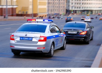 Moscow - 17 April 2021: Police Road Patrol Car With Flashing Police Lights  In Pursuit Of An Intruder's Car.