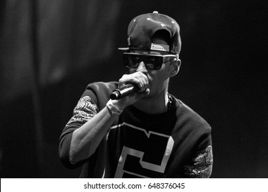MOSCOW - 2 OCTOBER,2014: Big concert of famous Russian hip hop band Centr in nightclub.Young white rap singer guy singing in microphone on stage.Rapper Rigos sing