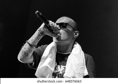MOSCOW - 2 OCTOBER,2014: Big concert of famous Russian hip hop band Centr in nightclub.Young white rap singer guy singing in microphone on stage.Rapper Guf on the scene