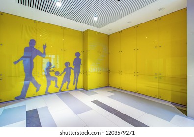 Moscow - 2018. Luxury Lobby Interior. Elevator Hall Of Residential Building With Colored Glass Panels On Walls With Inscriptions About Benefits Of Sports And Happy Family.