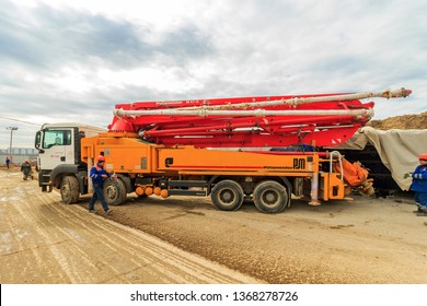 Moscow – 2019: Concrete pump is machine used for transferring liquid concrete by pumping. pump folded for transport. Boom concrete pump. Putzmeister truck-mounted concrete pump M47-5. PUMI - Shutterstock ID 1368278726