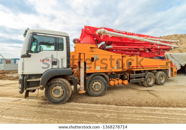 Moscow – 2019: Concrete pump is machine used for\
transferring liquid concrete by pumping. pump folded for transport.\
Boom concrete pump. Putzmeister truck-mounted concrete pump M47-5.\
PUMI