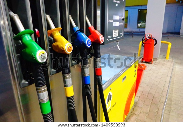 Moscow\
22-05-2019 Rosneft petrol station. Colorful fuel guns for ordinary\
and more environmentally friendly types of gasoline close\
up,company logo, fire extinguisher in\
background