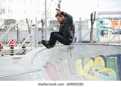 MOSCOW - 25 MARCH,2017: Young White Skater Guy Fly High In The Air On Aggressive Inline Skates In Outdoor Skatepark.Air Grab Trick On In-line Roller Skates