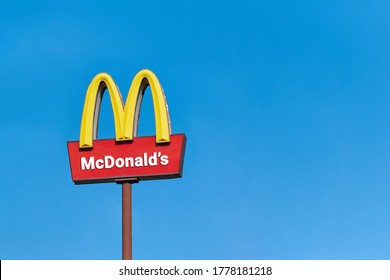 Moscow, 25.08.2019 - McDonalds roadside cafe logo, copy space. McDonald sign board, blue sky background. Drive thru fast food restaurant. Road outdoor advertising.