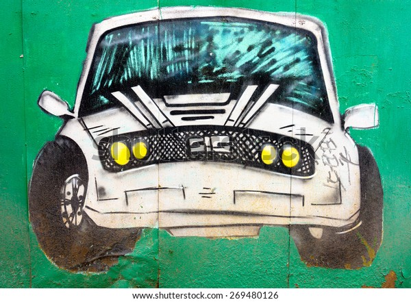 MOSCOW, April 14: Graffiti on\
the wall, painted white car on the green wall April 14, 2015 in\
Moscow.