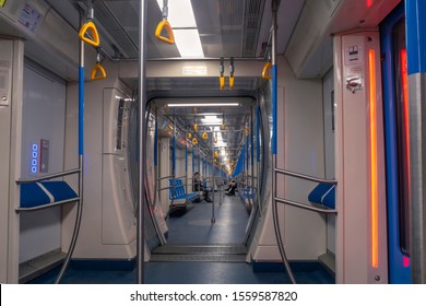 MOSCOW - August, 2019: Empty Modern Sunway Or Metro Train Interior. Blue Seats, Metal Handrails, Hanging Handholds, Highlighted Entrance Door.