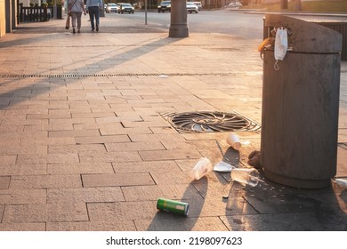 Moscow - August, 2022: Full Street Rubbish Bin And Some Rubbish On Tiled Sidewalk Outdoor.  Selective Focus.