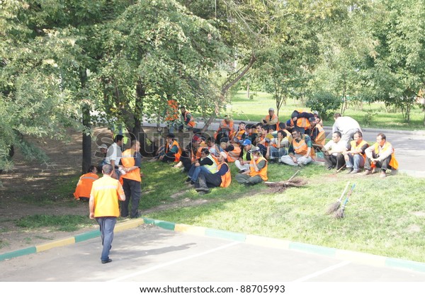 MOSCOW - AUGUST 30: Guest workers have a\
rest in a shade of trees on \