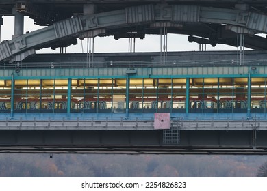 Moscow cityscape in autumn. The covered metro station Vorobyovy Gory (Sparrow Hills or Leninskiye Gory) on the bridge over the Moskva river. Passengers inside of the train. Photography at day. - Shutterstock ID 2254826823