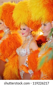 MOSCOW - DECEMBER 15: Beautiful Women In Orange Fake Fur Of Famous Parisian Cabaret Moulin Rouge In Moscow At Crocus City Mall On December 15, 2011 In Moscow, Russia.