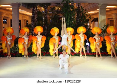 MOSCOW - DECEMBER 15: Girls In Orange Fake Fur And Pair Of Famous Parisian Cabaret Moulin Rouge Perform In Moscow At Crocus City Mall On December 15, 2011 In Moscow, Russia.